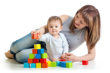 baby boy and mother playing together with  toys