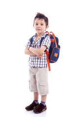 Smiling school kid standing with arms crossed against white back © cristovao31