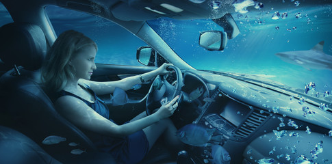 Beautiful girl underwater in the car