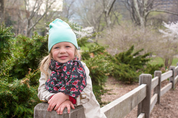 Pretty little girl at beauty autumn landscape background
