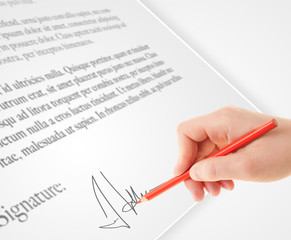 Hand writing personal signature on a paper form