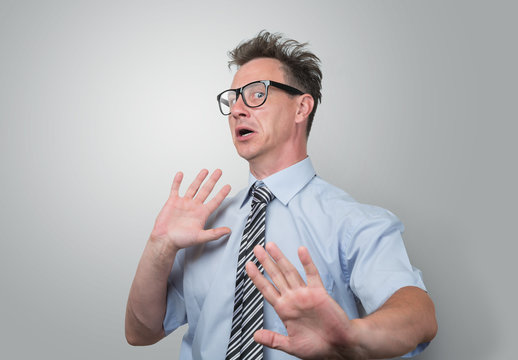 Surprised and scared businessman in glasses