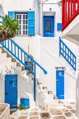 Traditional white houses with blue railing, doors and shutters i - 66578260