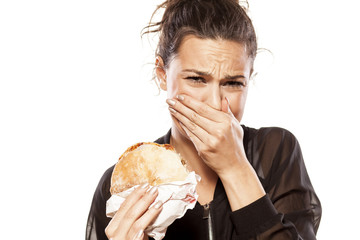 beautiful girl is disgusted by her sandwich