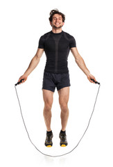 Athletic attractive man jumping on a rope on the white