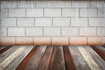 room interior vintage with grey brick wall and wood floor backgr