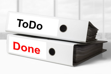stack of office binders todo list