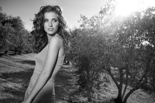 Beautiful  fashion model woman  in olive garden. Tuscan, Italy