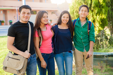 Happy teenagers hanging out at high school