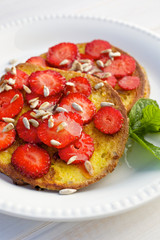 French toasts with fresh strawberries and sunflower seeds
