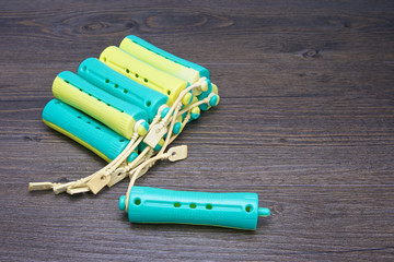 Close up blue and yellow plastic curler for hairstyle
