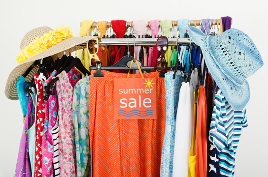 Clearance Rack With Colorful Summer Clothes And Sale Sign.