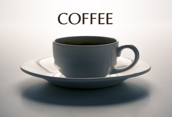 glass cup and saucer closeup with title coffee