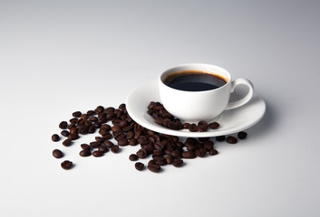 cup of black coffee with roasted coffe beans