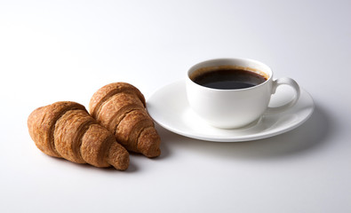 cup of black coffee with croissants