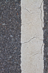 asphalt road with marking lines and tire tracks