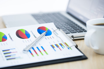 Businessman analyzing investment charts with laptop