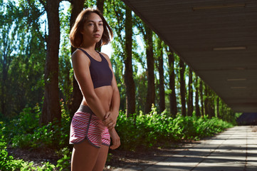 happy fit girl posing in the park