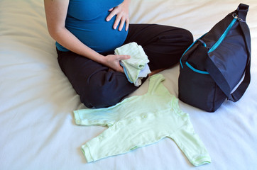 Pregnancy - pregnant woman packing a Hospital Bag