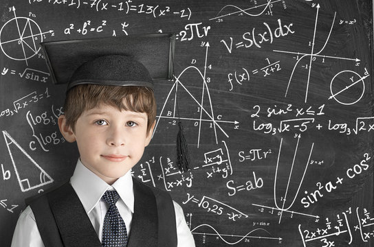 boy near blackboard with formulas