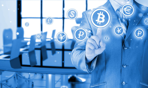 Choosing bitcoins, businessman pressing touch screen button.