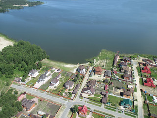 Aerial view onto private houses on bank of lake