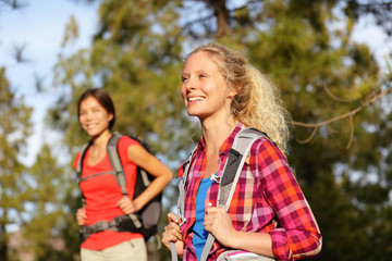 Active women - hiking girls walking in forest