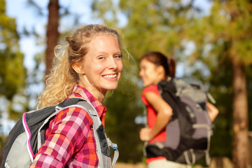 Hiking woman portrait smiling happy in forest