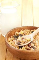 Plate with raw oatmeal on wooden table.