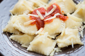 Close-up of italian ravioli with tomato sauce and cheese