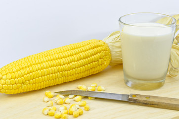 fresh corn with milk and knife