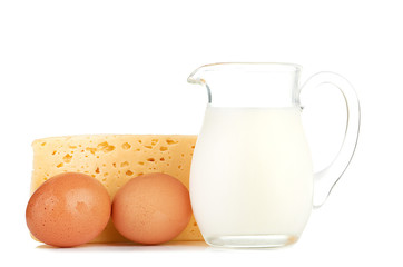 Big piece of cheese, glass jug with milk