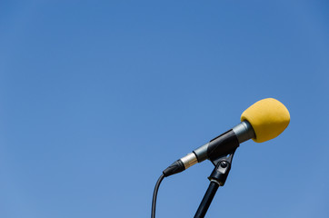 yellow microphone blue sky bakcground