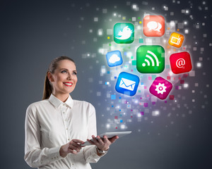 Young woman with tablet and colorful media icons
