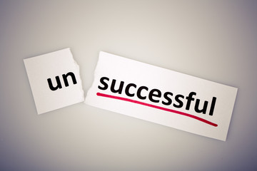 The word unsuccessful changed to successful on torn paper
