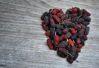 Shape of heart made of mulberry on wooden table
