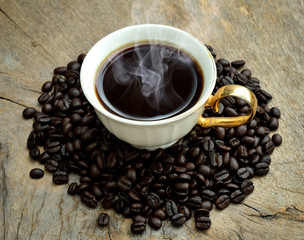 Cup of coffee on coffee beans background