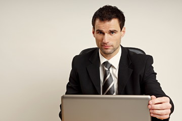 Handsome businessman in suit at the computer