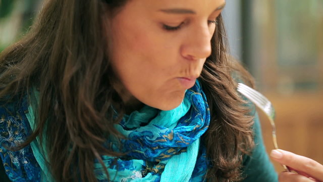 Woman eating meal in the restaurant, closeup, steadycam shot