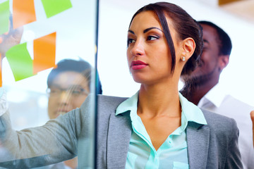 Businesswoman writes notes in the office