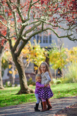 Fototapeta na wymiar Two fashion little girl in beautiful garden