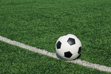 Obraz na płótnie Canvas Soccer ball green grass field