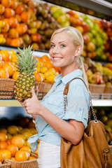 Girl at the shop choosing fruits and vegetables