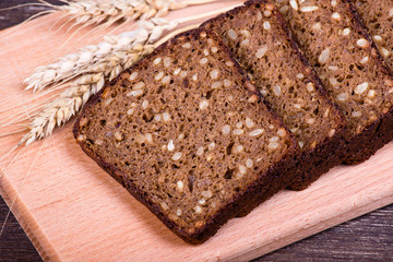 Fresh bread and wheat on the wooden