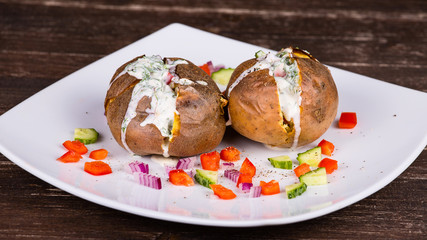 Baked potato with vegetables and sour cream
