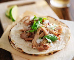 authentic mexican tacos with carnitas, cilantro and onion