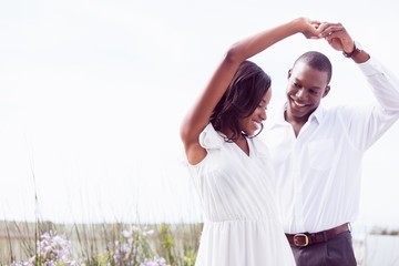 Romantic african american couple dancing and smiling