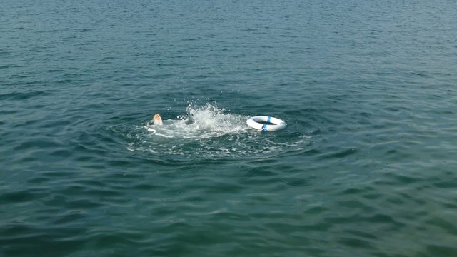 A man drowning somebody throws him a rescue buoy...