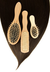 Shiny brown hair with combs isolated on white