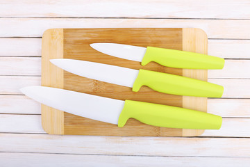 Kitchen knives and cutting board on wooden table